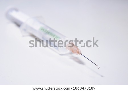 injection with corona, COVID-19 vaccine, extreme close up, free copy space, symbol picture