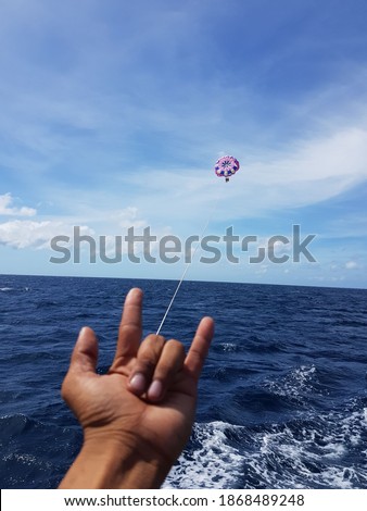 I did parasailing in Boracay and it was funny that the guide made the picture like Spiderman was shooting a spider web.