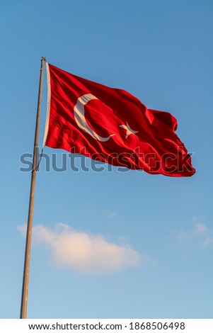 Turkish flag at sunset. Blue Background