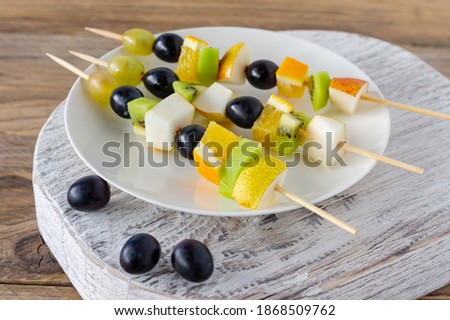 Catering table with fruit salad canape. Starter finger food.