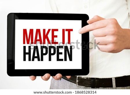 Text Make it happen on tablet display in businessman hands on the white bakcground. Business concept