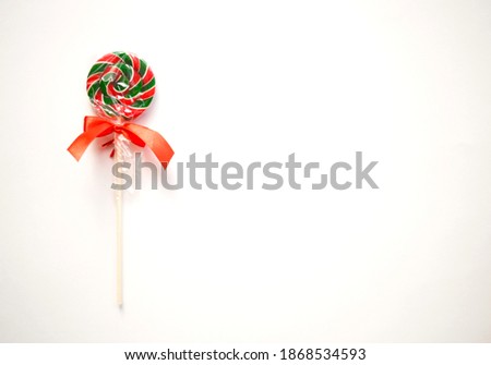 bright sweet christmas lollipop on white background.