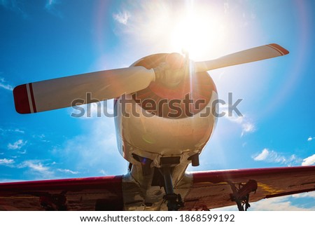 Single-engine aircraft propeller close up.