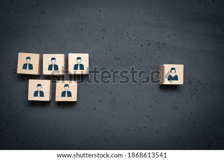 Wooden cubes with icons of men and an icon of women. Concept of discrimination against women at work, lack of equality.