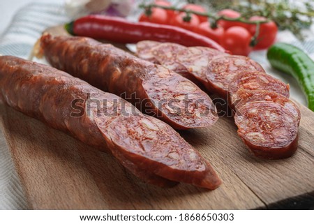 Traditional chorizo cuts with spices and ingredients on white surface