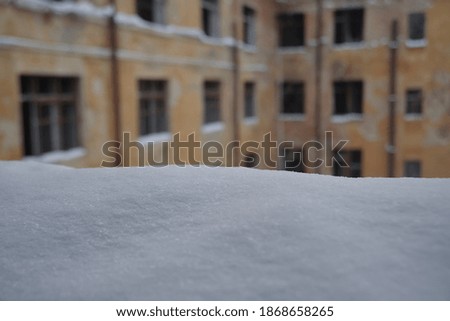 old residential window with snow landscape. Snowdrift on the window. Abstract winter backdrop.