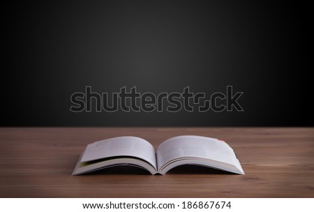 Open book on wooden deck and copy space