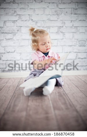 Little girl read magazine 
