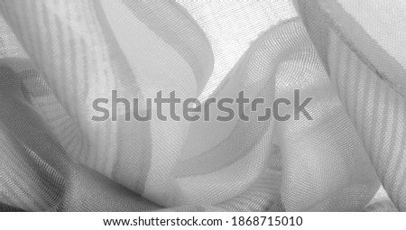 Texture. Background. Monochrome gray silk fabric, a photograph or picture developed or executed in black and white or in varying tones of only one color.