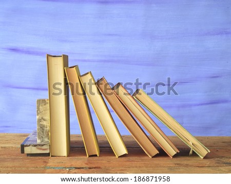 row of old books on blue background