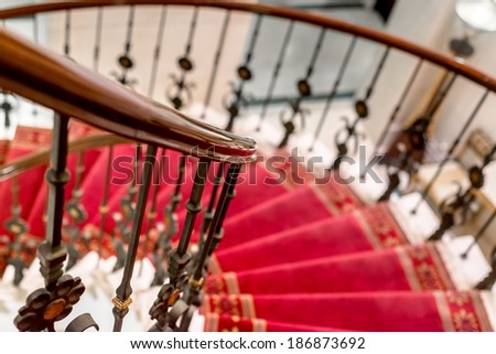 Elegant stairs closeup photo with red carpet