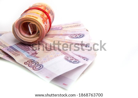 Banknotes, bills, coins of Russia, rolled up in a tube , isolated on a white background, panoramic banner format, close-up, space for text