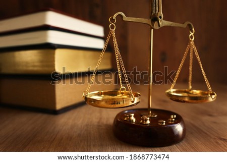 Vintage law scale over wooden table