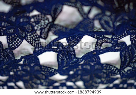 Lace fabric in blue. Pure cotton lace with floral pattern embellished with embroidery. Light Transparency. Textured. Background. Pattern