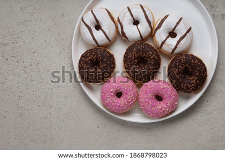 colorful donuts on rustic textured background