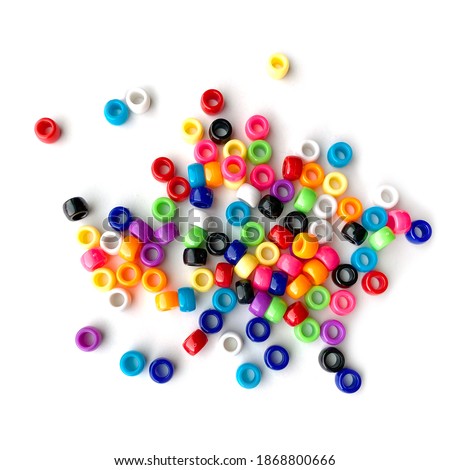 Colorful Rainbow Plastic Beads on White Background.  Kid's DIY Craft. Children's Necklace Beads Royalty-Free Stock Photo #1868800666