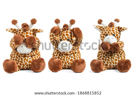 Plush giraffe toy isolated on white background covers eyes, nose and ears colored soft brown toy