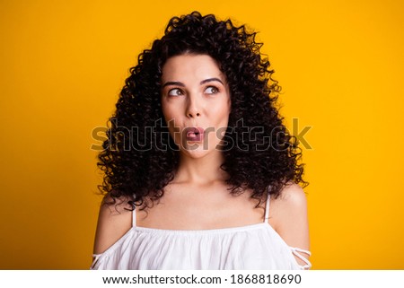 Photo portrait of curious interested woman looking at blank space whistling isolated on vivid yellow color background Royalty-Free Stock Photo #1868818690