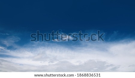 Panoramic abstract Nature sky background, texture for Design. Beautiful dark blue sky with white clouds above the horizon before rain. Wide Angle artistic Wallpaper or Web banner With Copy Space