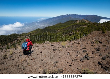 man hiking and photographing volcanic nature on canary islands
