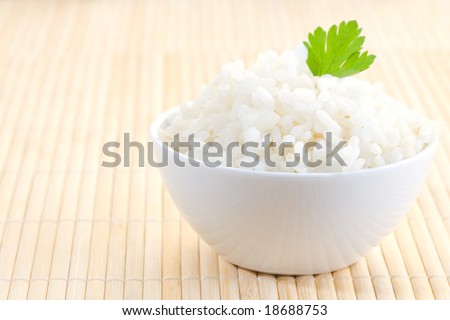 white bowl of boil chinese rice over bamboo Royalty-Free Stock Photo #18688753