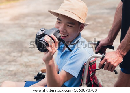 Disabled child on wheelchair is smiling,playing,learning in the outdoor park activity like other people,Lifestyle of special child, Life in the education age of children, Happy disability kid concept.