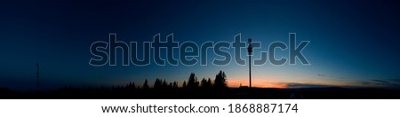 Panorama of internet station on the background of evening sky and forest