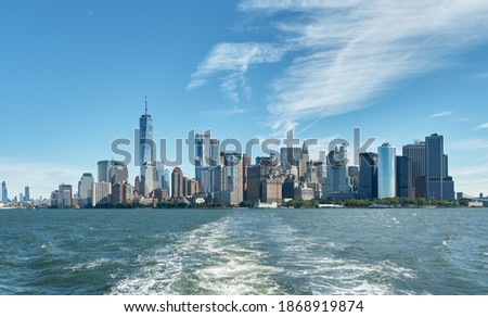 View of the architecture of Manhattan, its skyscrapers and the Hudson River, from a boat leaving the harbor