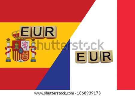 Spain and France currencies codes on national flags background. International money transfer concept