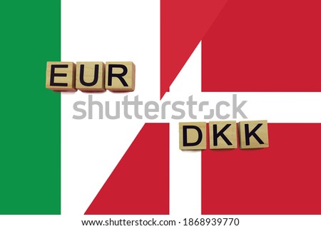 Italy and Denmark currencies codes on national flags background. International money transfer concept