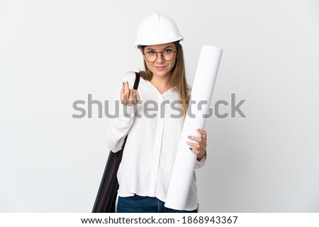 Young Lithuanian architect woman with helmet and holding blueprints isolated on white background making money gesture