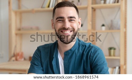 Banner panoramic view of smiling Caucasian male employee have video call or webcam digital virtual conference at workplace. Headshot portrait of happy businessman at workplace. Employment concept.