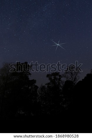 One bright star above silhouetted trees near Raeford NC