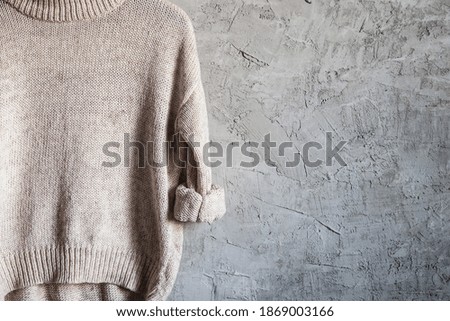 Beige Warm Long Sleeve Shirt on Black Hanger Hang on gray background