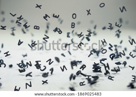 Letters of the alphabet falling and flying in levitation in the air