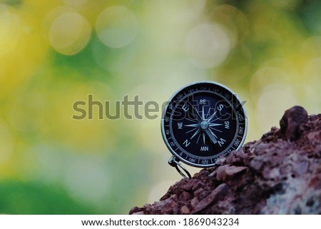 close up compass on stone, nature copy space background for text, travel bubble, relaxation and lifestyle, planning and manage to success business concept