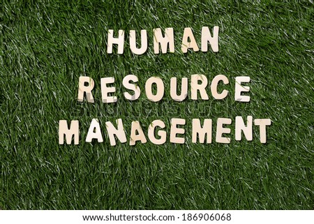 Human resource management wooden sign  on green grass background