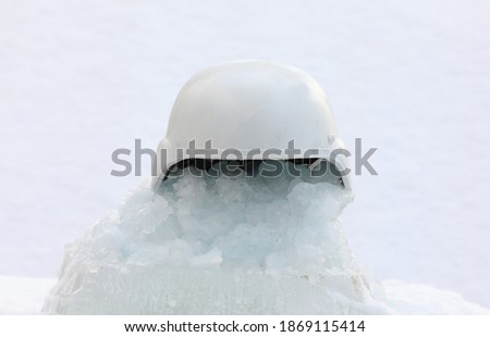 white military helmet on the snow