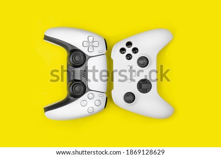 Next gen games controllers on yellow background. Royalty-Free Stock Photo #1869128629
