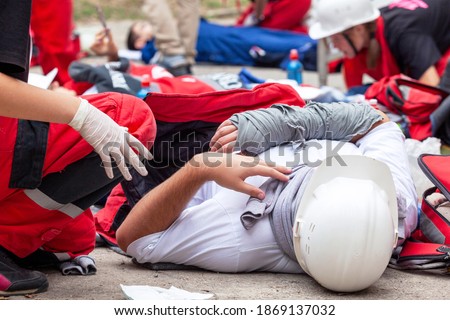Workplace or work accident at construction site. First aid training. Royalty-Free Stock Photo #1869137032