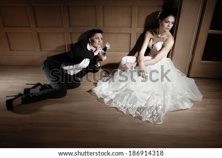 Woman  photographer taking a picture of bride