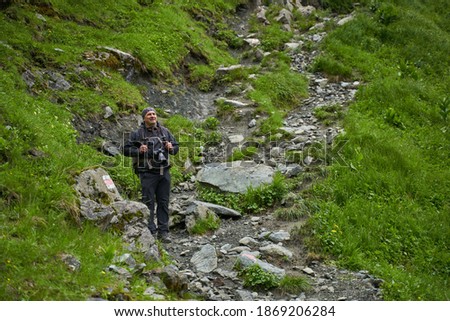 Man hiker taking pictures on mountains