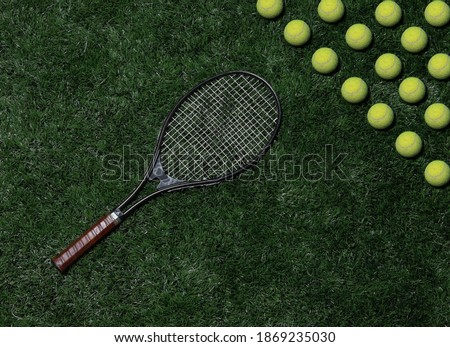 Tennis racket with a ball on the grass. Pattern of balls. Can be used as a background. Empty space for text