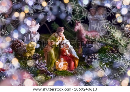 Christmas card with figures of Jesus, Virgin Mary and Joseph on a dark background