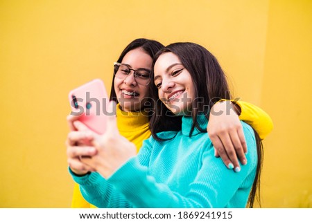 Two beautiful woman with brackets smiling taking a selfie. technology concept. selective focus.