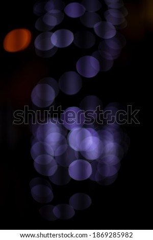 abstract unfocused vertical picture industrial soft blue color bokeh lights on black background space 