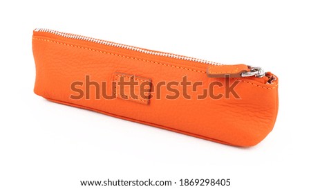 New orange leather pencil case isolated on white background