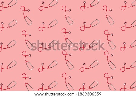 Modern banner with red stethoscopes on soft pink background. Medical equipment. Medicine concept. Health care concept. Flat lay.