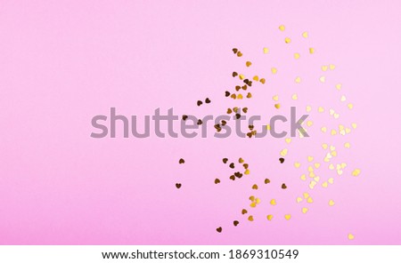 small shiny confetti hearts on a pastel pink background. background Valentine's day, women's holidays, mother's day