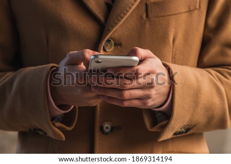 close-up of hands with mobile phone
